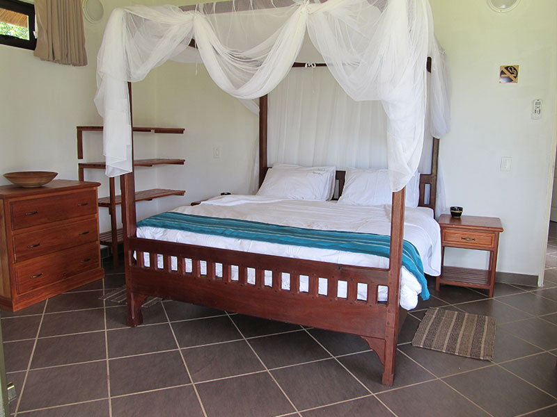 Spacious bedroom opening to the beachfront